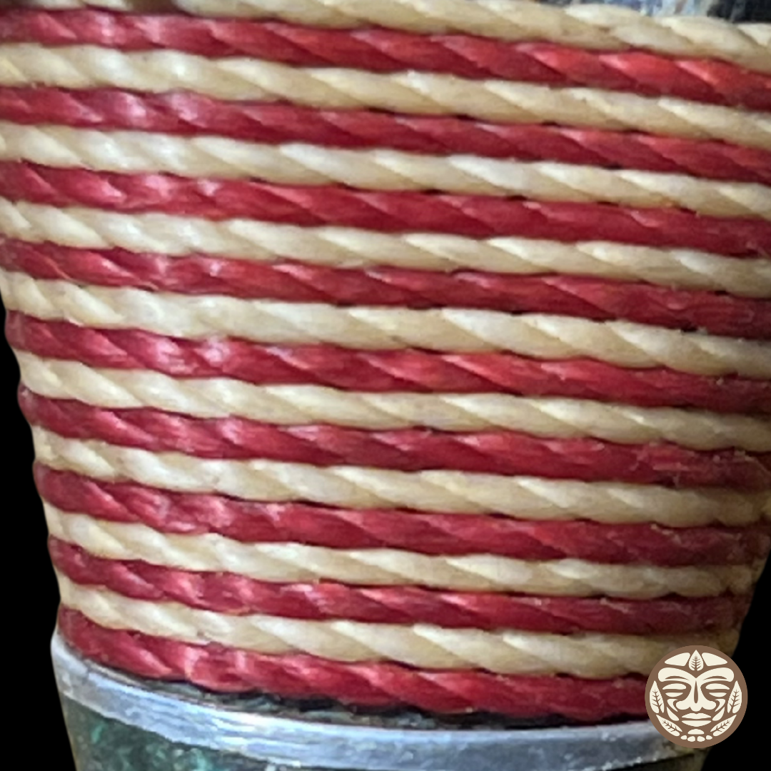 A close-up of a wrapped chambira rope kuripe horizontal stripes of deep red and natural beige.